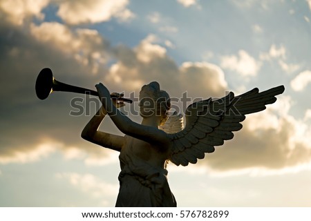 silhouette of angel blowing golden horn during sunrise against dramatic sky 