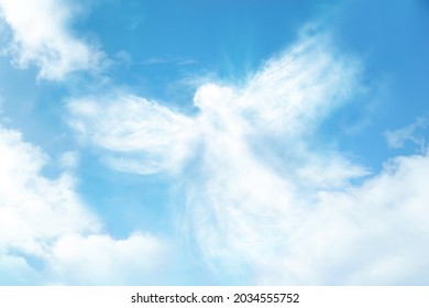 Silhouette Of Angel Made Of Clouds In Blue Sky 