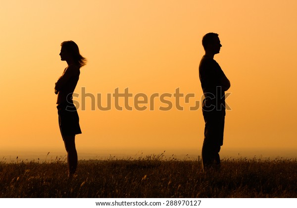 Silhouette of a angry woman and man on each\
other.Relationship\
difficulties