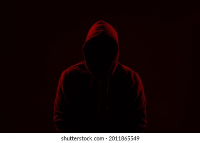 Silhouette Of Anonymous Man On Dark Background, Toned In Red