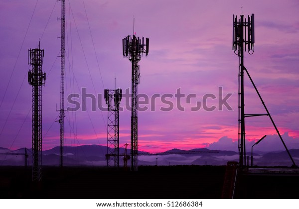 Silhouette\
Antenna tower and repeater of Communication and telecommunication\
with the mountain on the background of\
sunset.