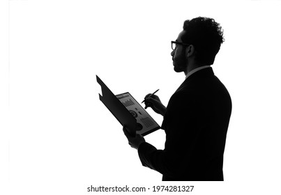 Silhouette of arabian businessman holding document file.