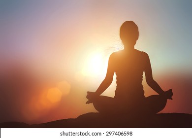 Silhouette Asia Woman With Tree Pose Yoga On The Mountain At Pastel Sunset Background