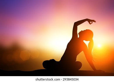 Silhouette Asia Woman Yoga On The Beach At Sunset.