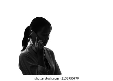 Silhouette Of Asian Woman Calling With A Smart Phone.