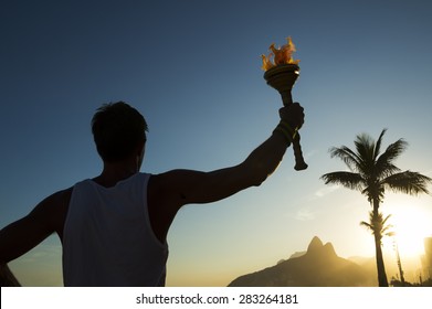 Silhouette Of Athlete Standing With Sport Torch At The Rio De Janeiro Brazil Sunset Skyline At Ipanema Beach