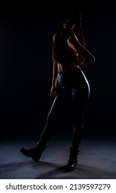 Silhouette Of Attractive Girl Is Posing While Dressed In All Black Clothes