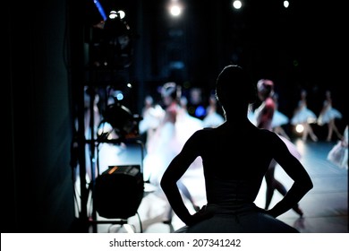 Silhouette of ballerina on background of ballet performance, backstage