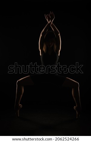 Similar – Close up front portrait of one young middle age athletic woman in sportswear in gym over dark background, standing in boxing stance with hands and fists, looking at camera