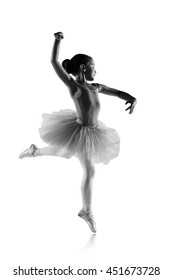 Silhouette Of Ballet Dancer Girl In Pointe And Tutu Isolated On White, Little Ballerina Is Spinning On One Leg Dancing And Jumping. Education Lessons In Classic Dance School Black And White