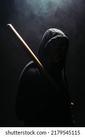 Silhouette Of Bandit Holding Baseball Bat On Black Background With Smoke