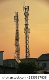 silhouette of base transceiver station (BTS) tower on late afternoon with beautiful golden sky. BTS is equipment that facilitates wireless communication between user equipment and networ 