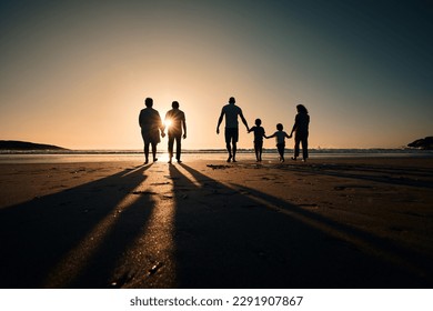 Silhouette, beach and big family holding hands in sunset on a holiday or vacation at sea or ocean together. Travel, love or shadow of people at sunrise in support, freedom and bonding by water mockup - Powered by Shutterstock