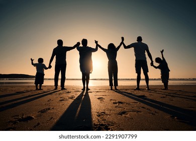 Silhouette, beach and family holding hands in sunset on a holiday or vacation at sea or ocean together. Travel, love and shadow of people celebrate in support, freedom and bonding at night or evening - Shutterstock ID 2291907799