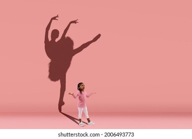 Silhouette of beautiful ballerina. Childhood and dream about big and famous future. Conceptual image with girl and shadow of female ballet dancer on coral pink wall. Sport, dreams, education concept. - Shutterstock ID 2006493773