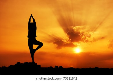 Silhouette of a beautiful Yoga woman in the morning