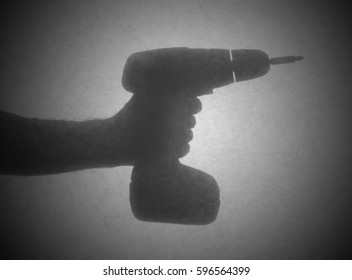 Silhouette behind a transparent paper - Cordless drill - Powered by Shutterstock