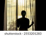 Silhouette Behind a Woman Opening the Curtains And Looking Of Sunset View In The Evening Time