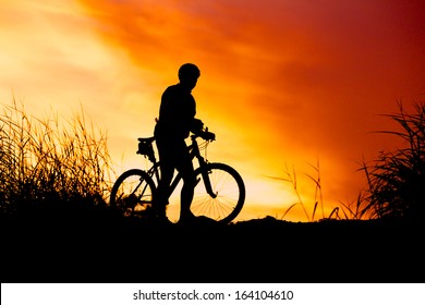 Silhouette Of Bicycle Rider At Sunset