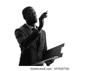 Silhouette of black engineer holding file. - Powered by Shutterstock