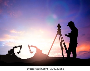 Silhouette Black Man Survey And Civil Engineer Stand On Ground Working In A Land Building Site Over Blurred Construction Worker On Construction Site. Examination, Inspection, Survey