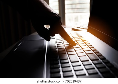 Silhouette black and white hands of anonymous hackers typing code on keyboard of laptop for remotely reach and receiving personal information online networking, Internet Crime Payment Security Concept - Shutterstock ID 702519487
