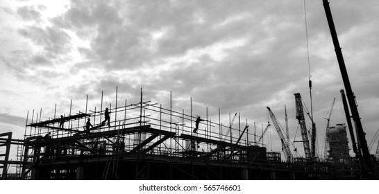 Silhouette Black And White Shot Of Oil Construction Site With Worker And Mega Cranes.