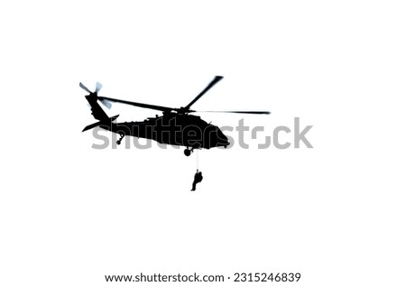 Silhouette of Blackhawk Helicopter iwth Rescuer