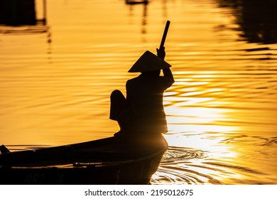 Silhouette of boat man with Vietnamese hat, Hoi An, Vietnam
