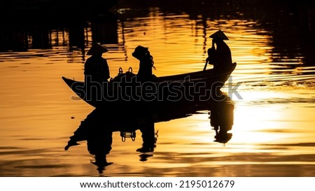 Silhouette of boat man with Vietnamese hat, Hoi An, Vietnam