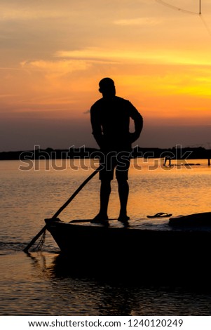 Silhouette of boatman at the time of sunset - Burullus Lake - Kafr El Sheikh , Egypt