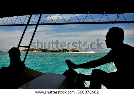 silhouette of A boatman  view from from the boat  with blue sky and clear water as background