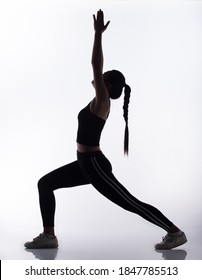 Silhouette Body Of Young Fitness Woman Play Sweat Yoga And Stretch Muscle For Slim Sexy Shape. High Contrast White Background Copy Space