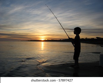 Silhouette Of Boy Fishing