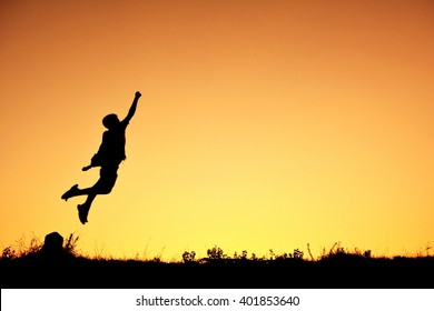 Silhouette A Boy Flying At Sky Sunset