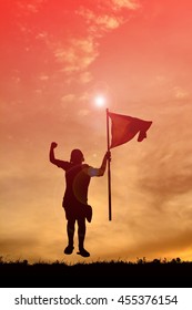 Silhouette boy holding flag at sunset. Concept success - Shutterstock ID 455376154