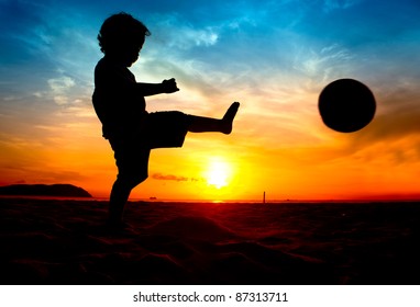 silhouette of boy kick the ball at sunset - Powered by Shutterstock