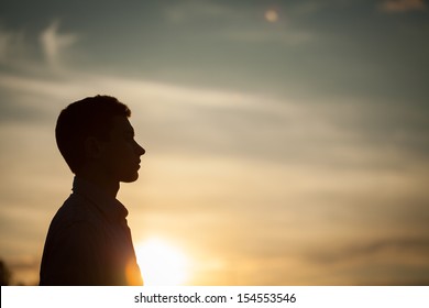 Silhouette Of Boy On Sea Sunset