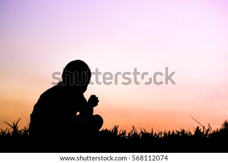 The silhouette of boy sitting alone, concept of lonely, sad, alone and scared
