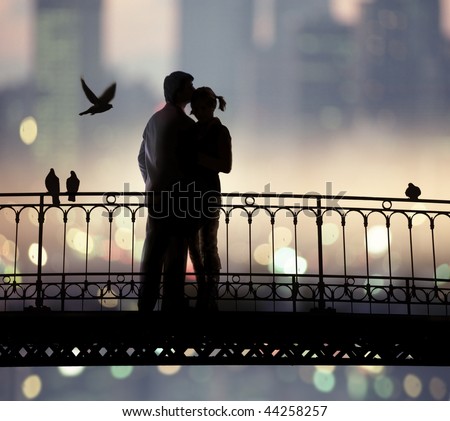 silhouette of bridge and pair of lovers on city background