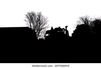 Silhouette Of A British Army Soldier Navigating From The Cabin Roof Of A MAN SV 8x8 EPLS Truck On A Military Exercise, Wiltshire UK  