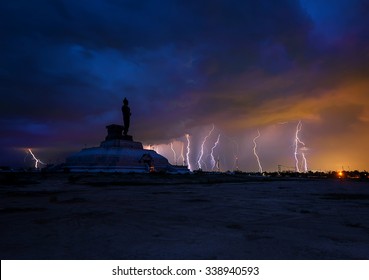 Silhouette buddha statue in unseen lightning on partly cloudy of twilight Phutamonthon Park ,Khonkaen Province,Thailand