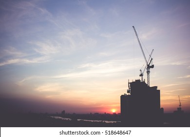 Silhouette Of Building Under Construction With Crane During Sunset, Vintage Filter