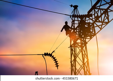 Silhouette Business Industrial Electrician for the installation of electrical systems for alternative energy heavy industry concept over blurred pastel background sunset 