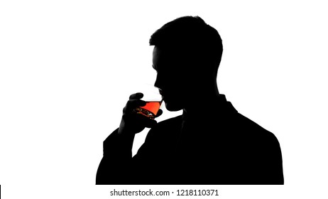 Silhouette of business man drinking whiskey, enjoying taste of aged beverage