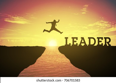 Silhouette of business man jump between the hills. jump to leader text. keep going to leaders concept at 2018 over a beautiful sunset or sunrise at the sea background. success in 2018 years