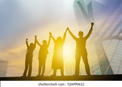 Silhouette Of Business People Celebration Success Happiness Team At Sunset Evening Sky Background