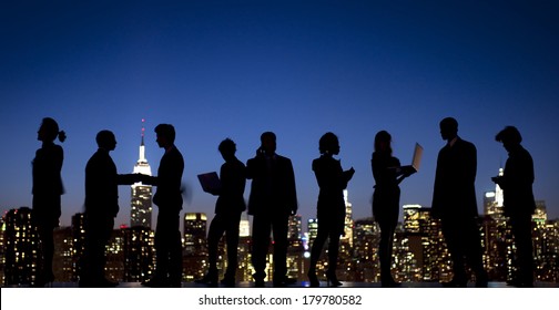 Silhouette Of Business People Interacting With New York Skyline