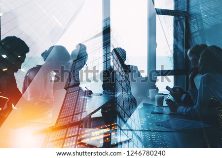 Silhouette of business people work together in office. Concept of teamwork and partnership. double exposure with light effects