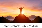 Silhouette of a business person on the top of a mountain peak in sunset background. Winner and conquer of businessman concept.